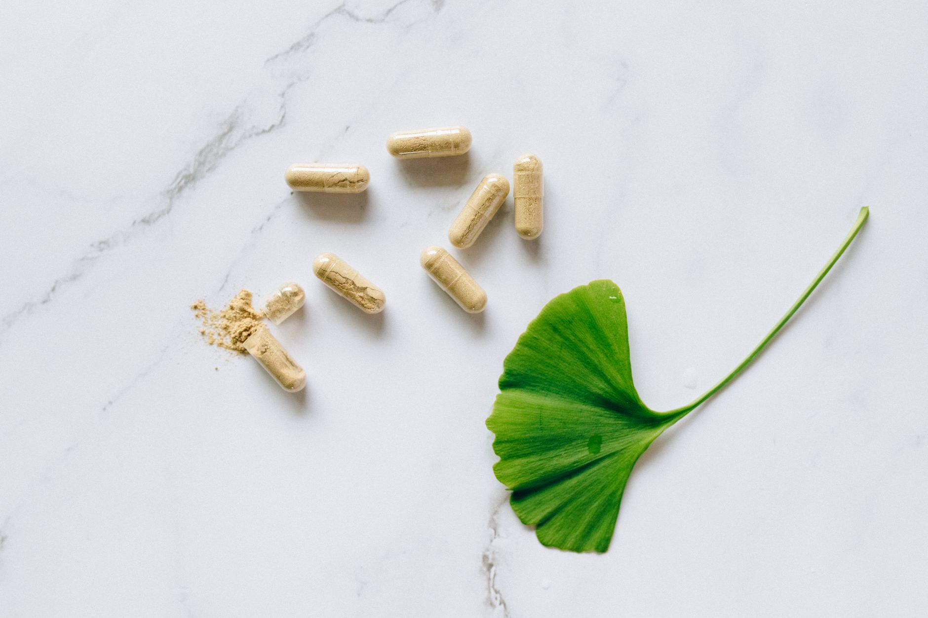 Herbal supplements and adaptogen powders on a wooden surface